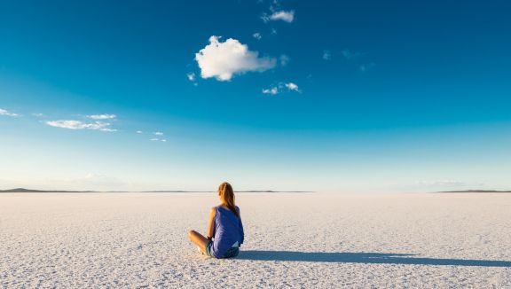 Girl sitting on the salt pan of Lake Gairdner (South Australian Tourism Commission)