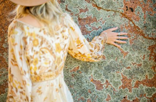 Woman touching the rock at Murphy's Haystacks (Tourism Australia)